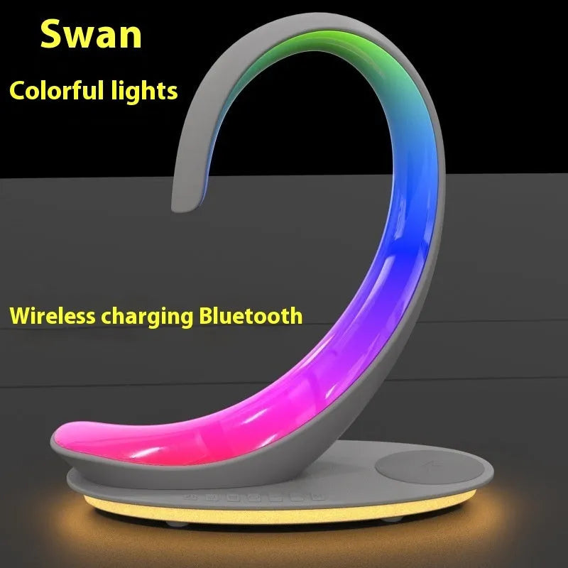 White swan-shaped desktop wireless charger with Bluetooth speaker and colourful ambient lighting