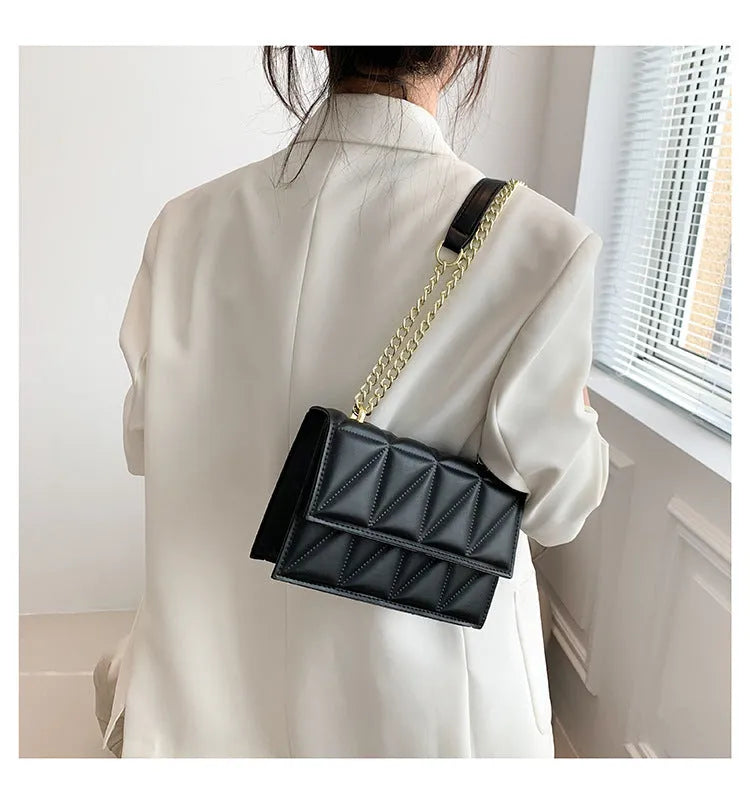 Small square PU chain crossbody bag in horizontal shape with spliced detail, available in five colours.