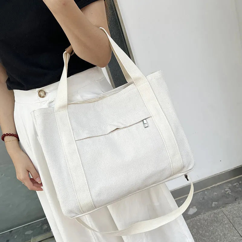 Large canvas tote bag with multiple internal compartments in horizontal square design