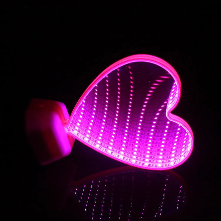 Rose red double-sided love tunnel shape LED decorative light on a flat surface.