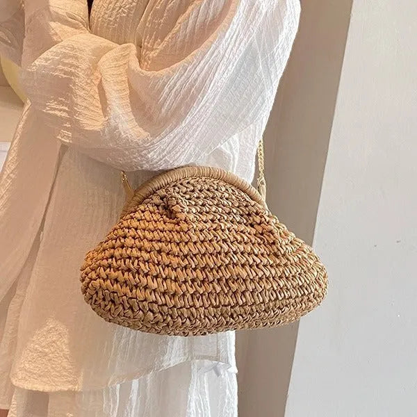Women's woven straw shoulder bag with shell shape in khaki colour featuring chain detail