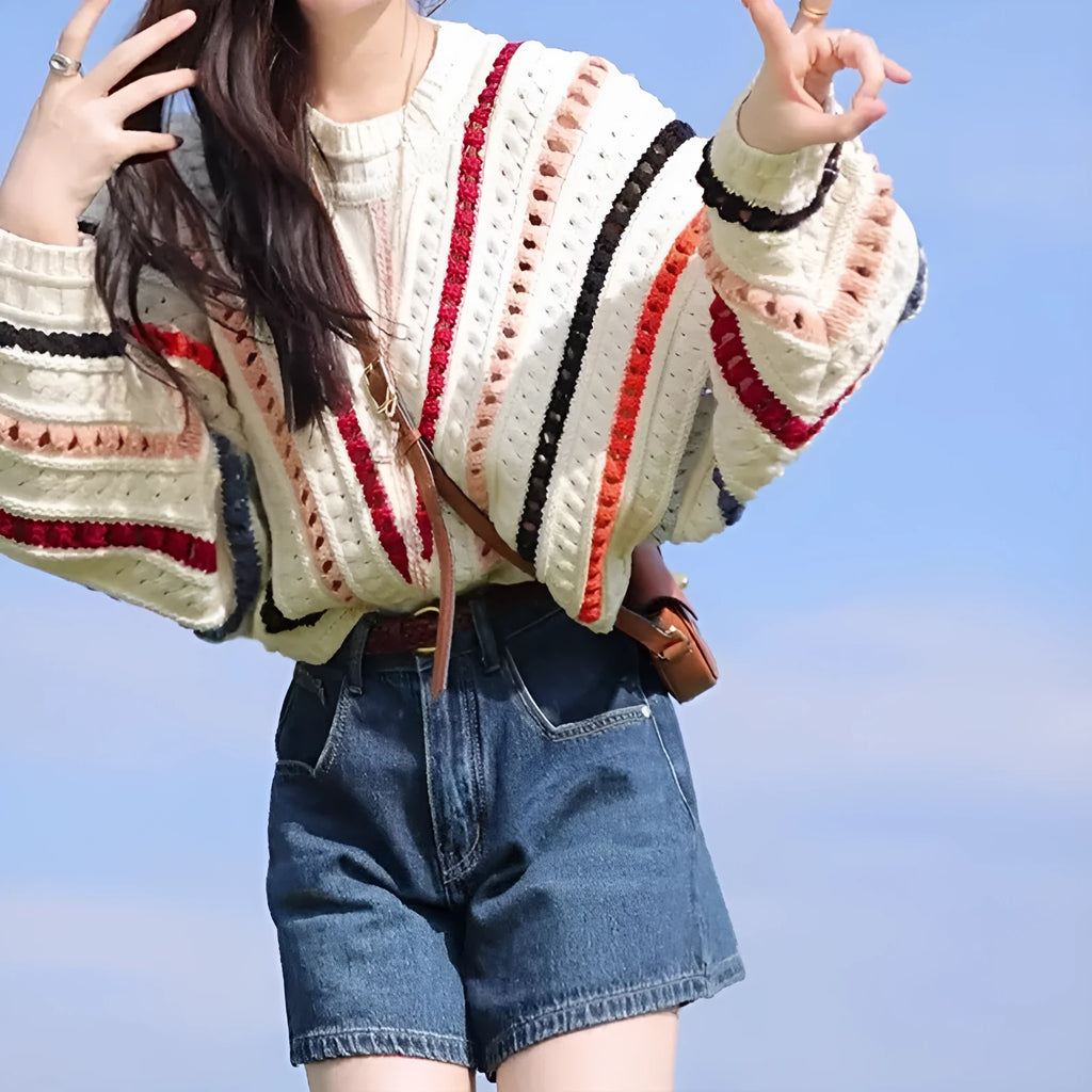 Women's rainbow striped batwing sleeve pullover sweater with a loose fit and round neck.