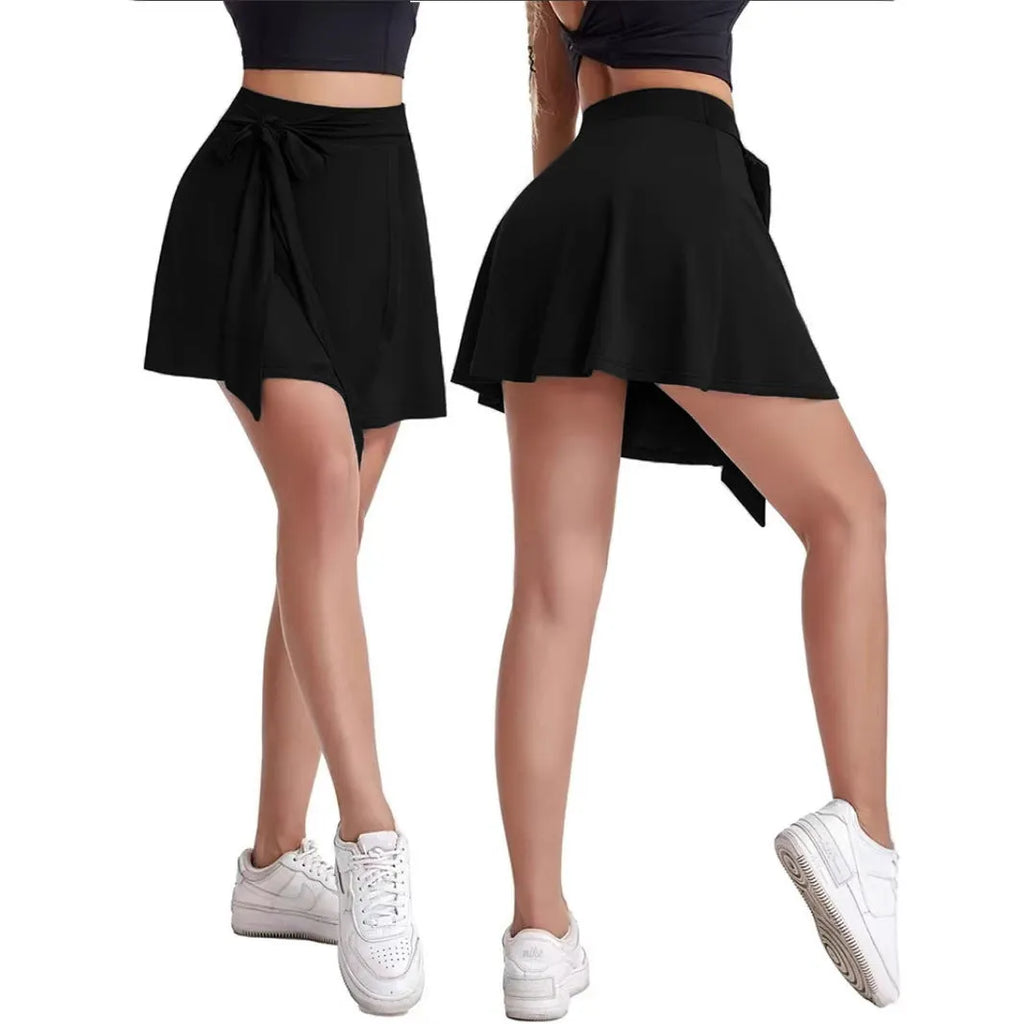 Black thigh-length sports culottes with built-in safety shorts and shoulder strap detailing