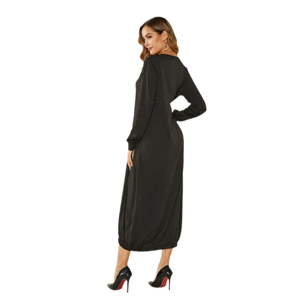 A loose black lantern dress with a lace-up crew neck, shown on a model.