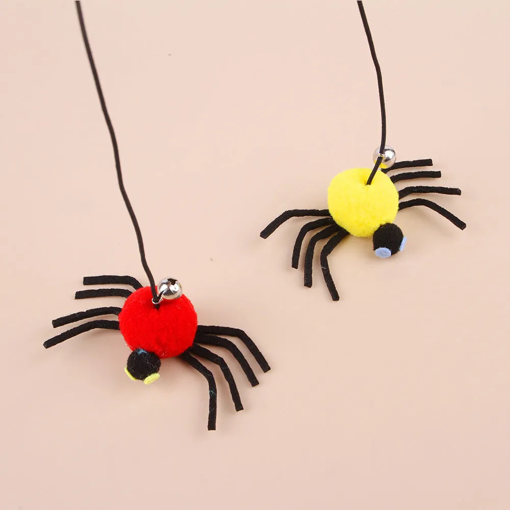 Red and yellow hanging door cat toy with feather, bell, spider, and elastic rope for interactive pet play