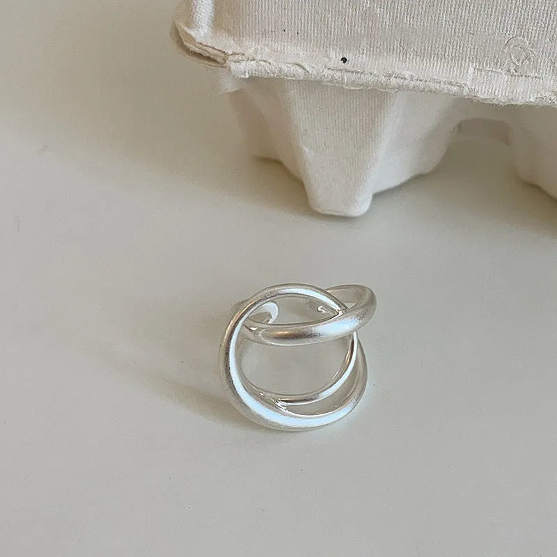 Three-dimensional interlaced geometric open ring in matte metal with gold electroplating