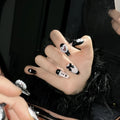 Black and pink heart design hand-painted manicure nails with cat's eye styling