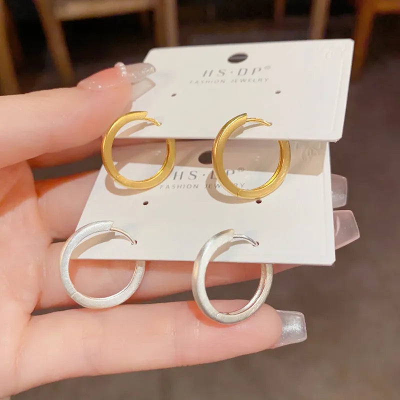 Geometric round eyelet ear clip jewellery in gold colour with real gold plating on copper material