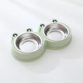 Blue stainless steel frog-shaped double pet bowl for food and water on a floor.