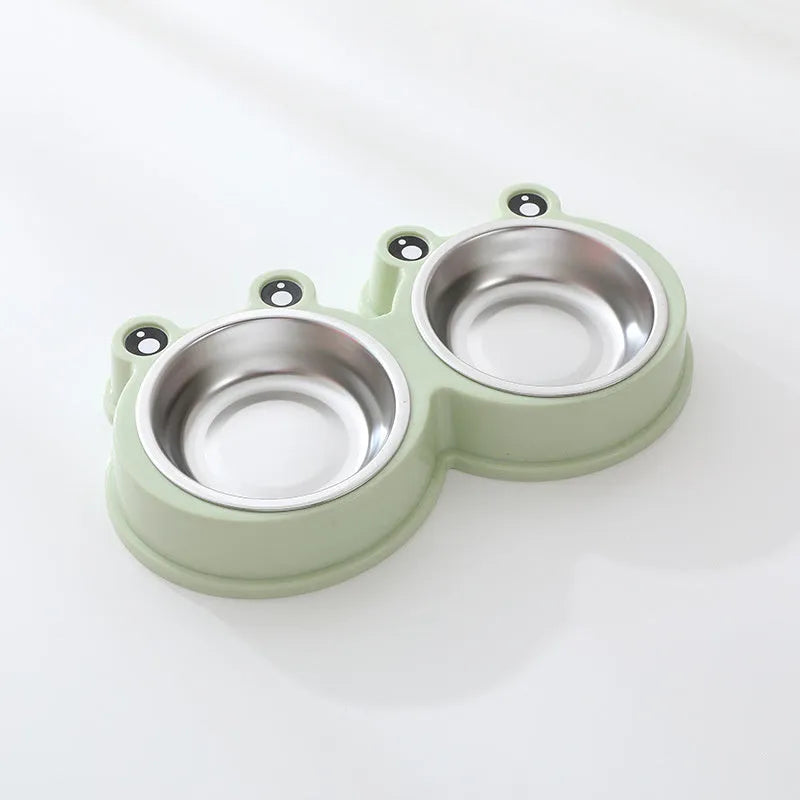 Blue stainless steel frog-shaped double pet bowl for food and water on a floor.