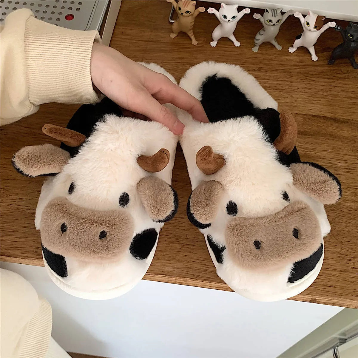 White cow pattern slippers with faux fur upper and textured non-slip soles
