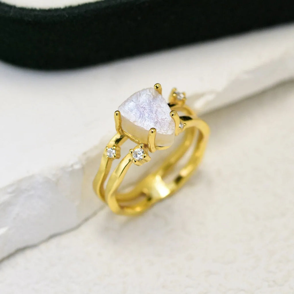 S925 sterling silver ring with irregular triangle design holding a moonstone, shown in rose gold plating.