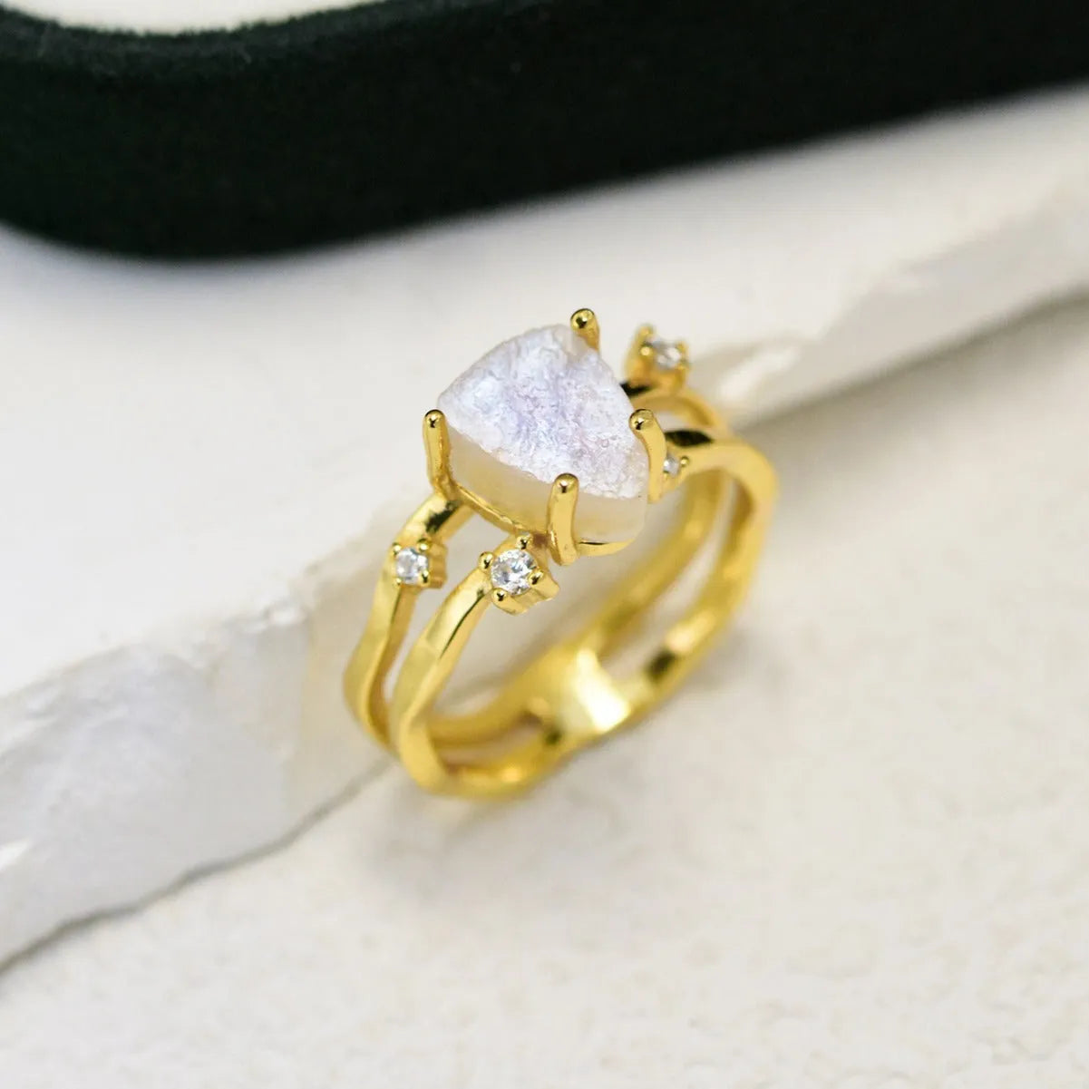 S925 sterling silver ring with irregular triangle design holding a moonstone, shown in rose gold plating.