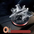Solar powered rotating silver fighter jet perfume ornament with aluminium alloy base on a car dashboard