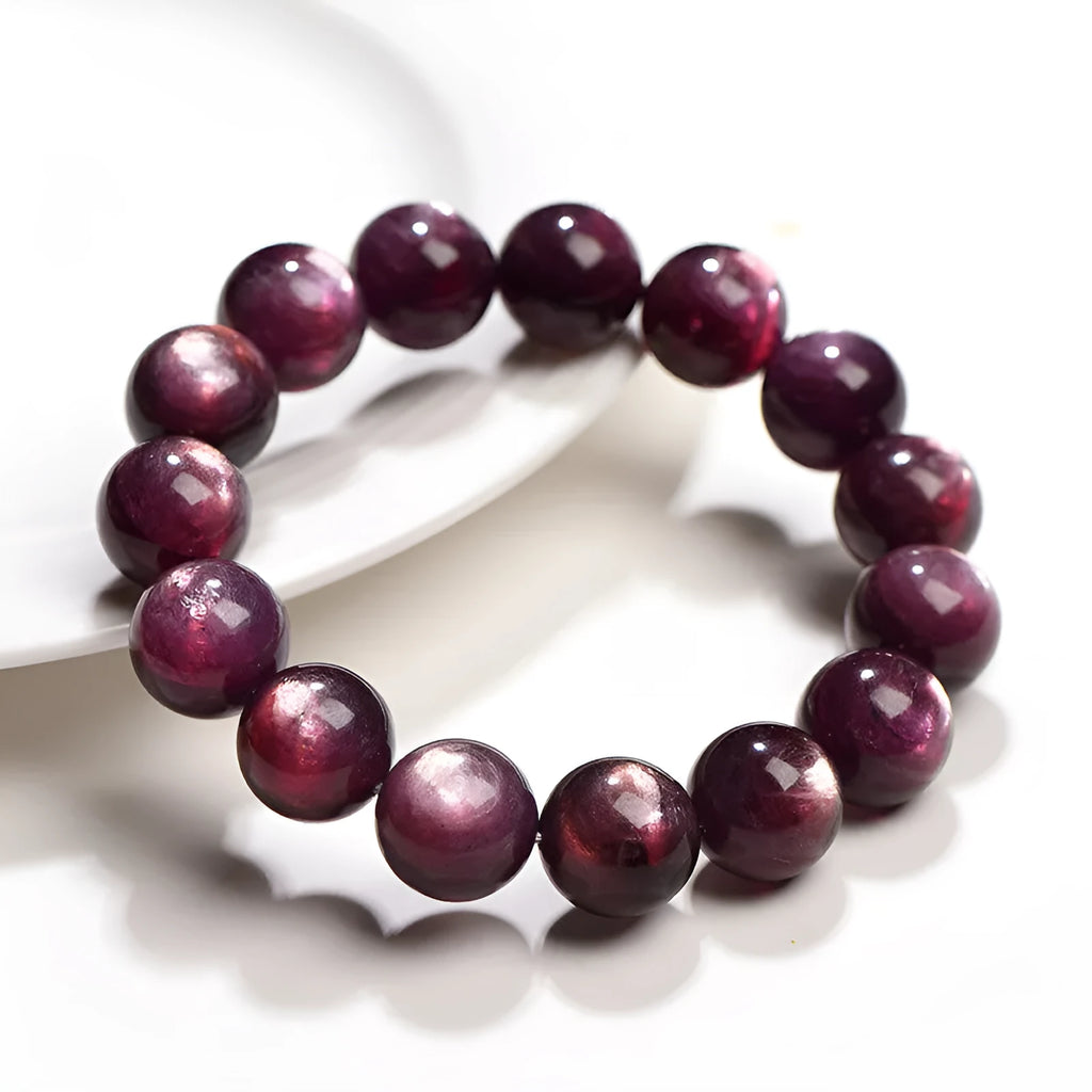 Purple lepidolite crystal bracelet showing polished round beads on adjustable string in natural lighting
