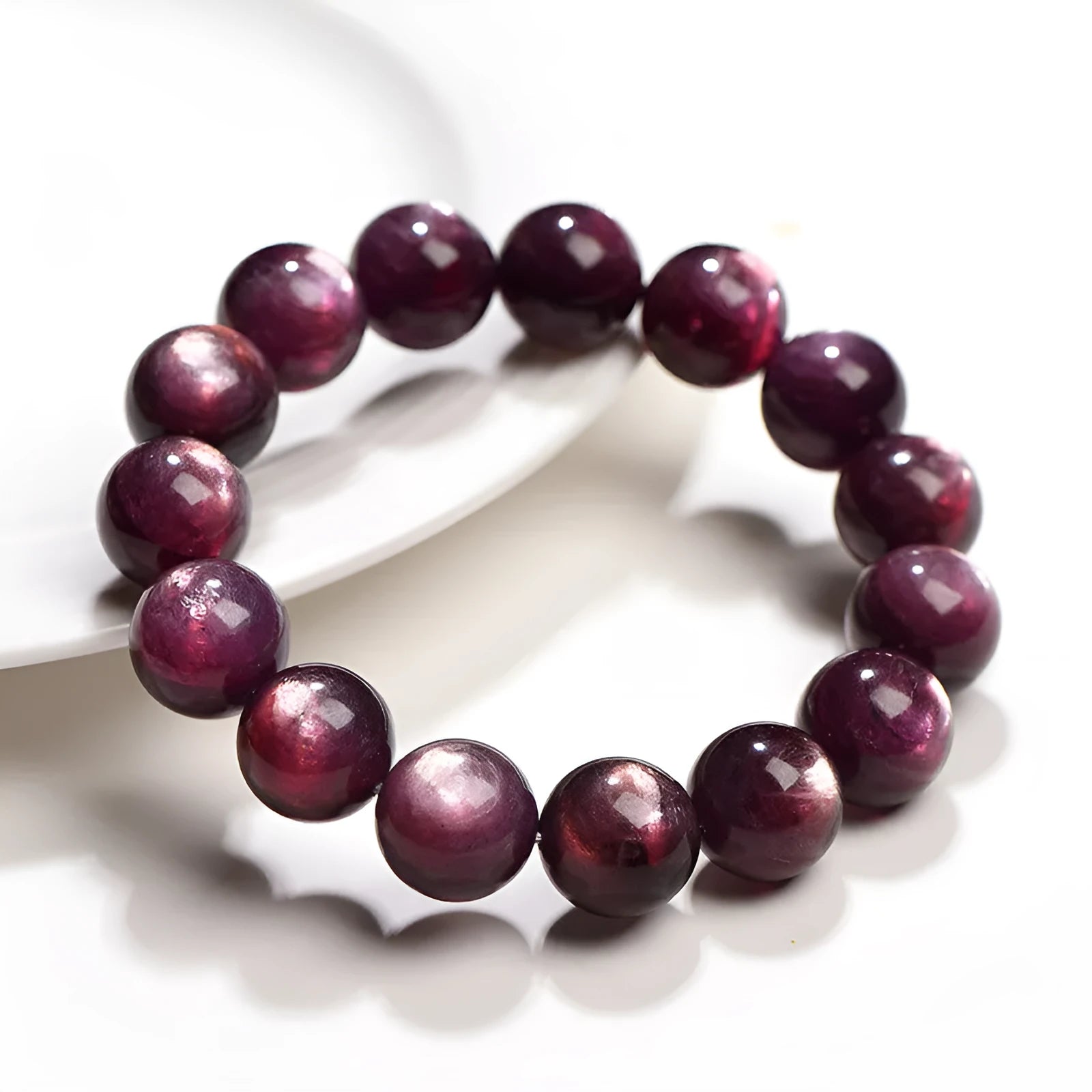 Purple lepidolite crystal bracelet showing polished round beads on adjustable string in natural lighting