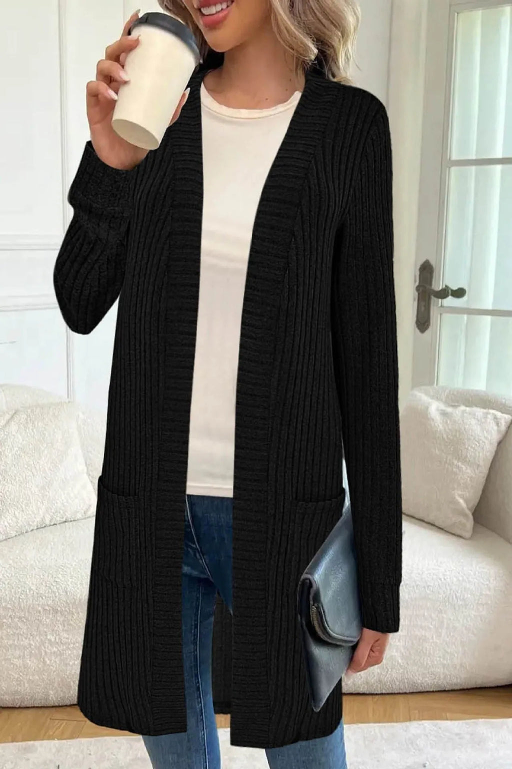 Loose fit grey knitted cardigan jacket with long sleeves and patch pockets on a hanger.