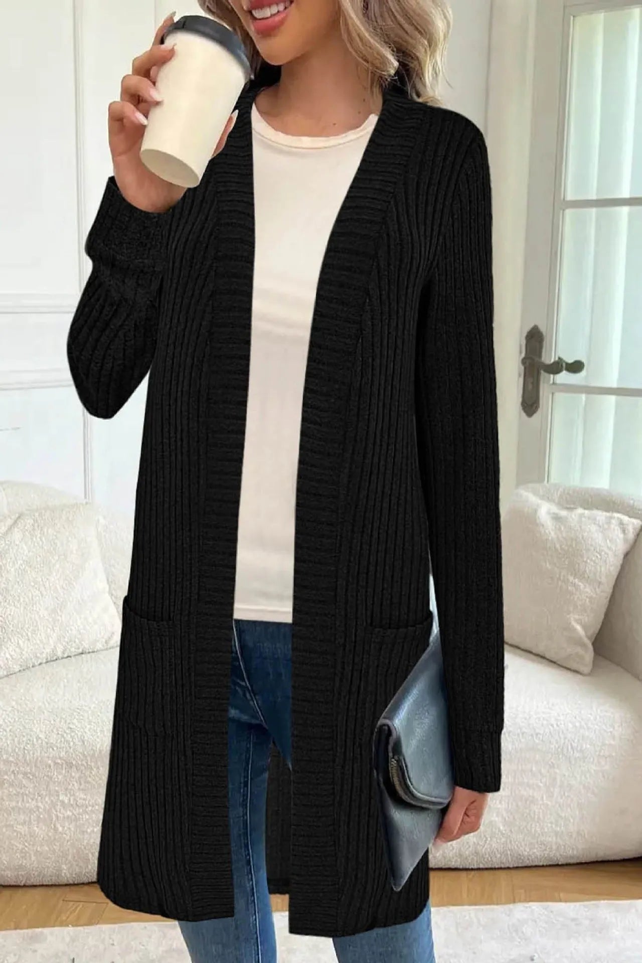 Loose fit grey knitted cardigan jacket with long sleeves and patch pockets on a hanger.