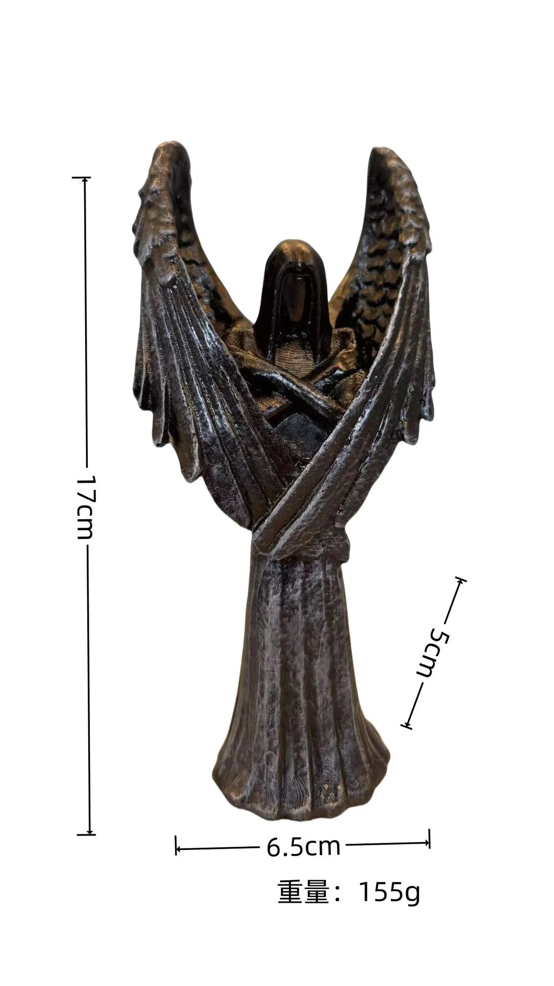 Small dark angel resin statue ornament on a table, showing detailed wings and robe.