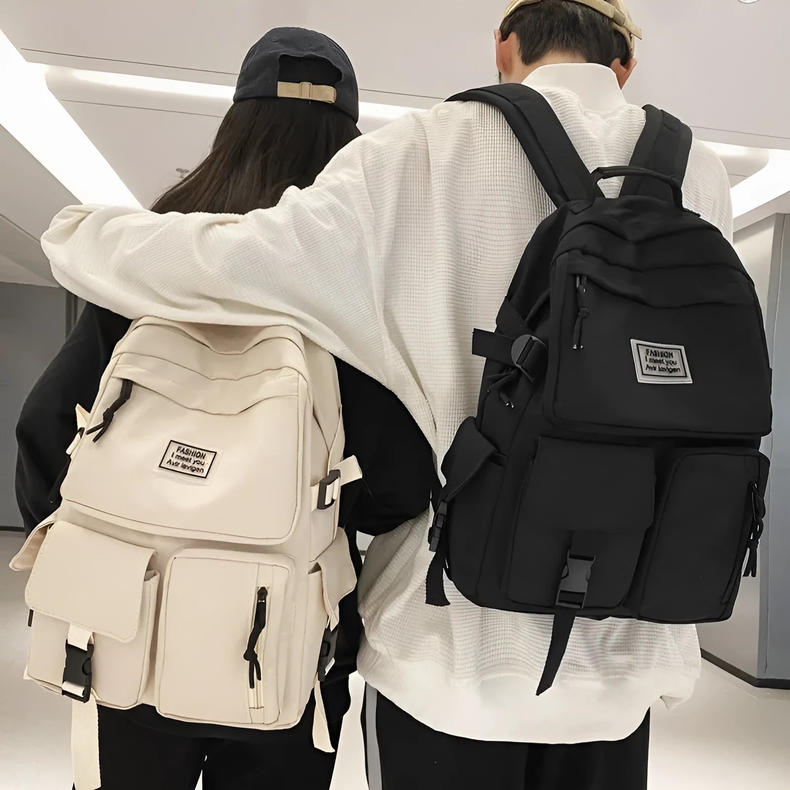 Black nylon student backpack showing front three-dimensional pocket and internal laptop compartment.