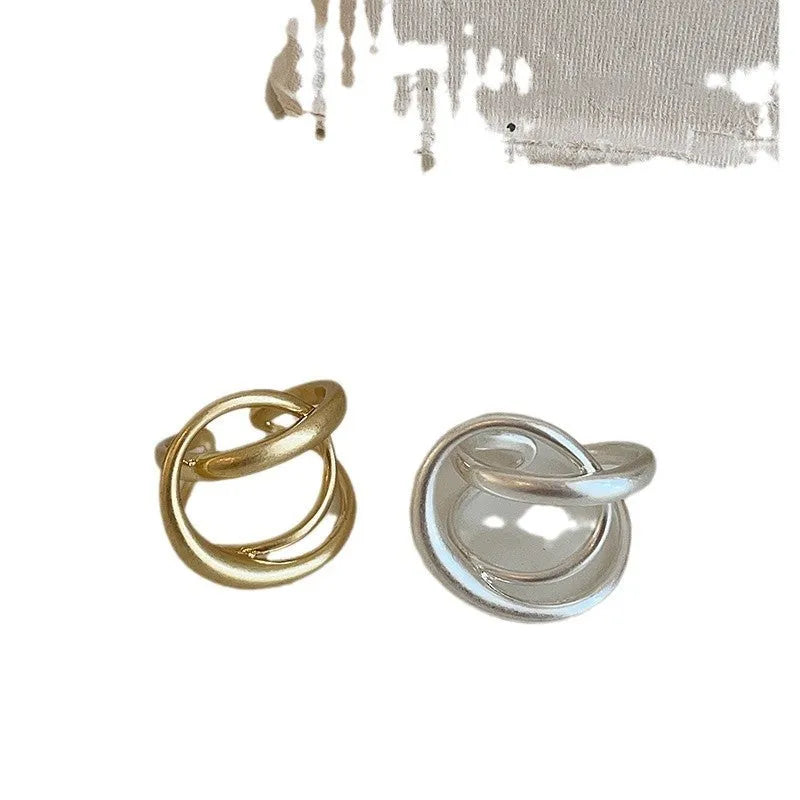 Three-dimensional interlaced geometric open ring in matte metal with gold electroplating