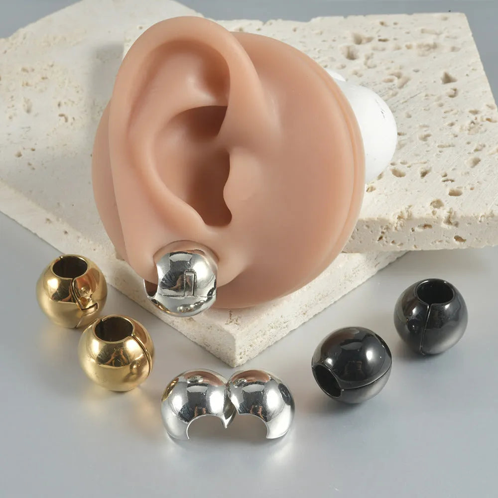 Stainless steel hollow skull Buddha earring for auricle piercing in hip hop style.