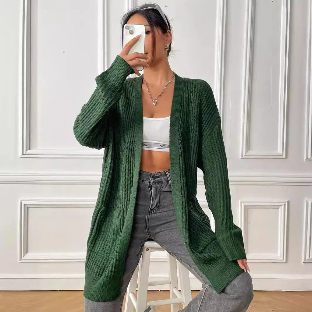 Women's dark green loose-fit cardigan with two front pockets and long sleeves.