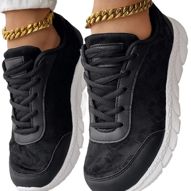 Women's white canvas casual running shoes with flat soft sole on a plain background