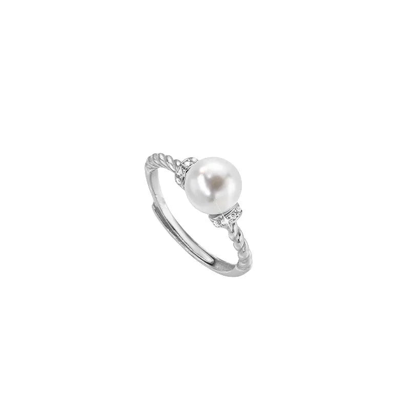 Adjustable antique twist design copper ring with pearl inlay in gold colour.