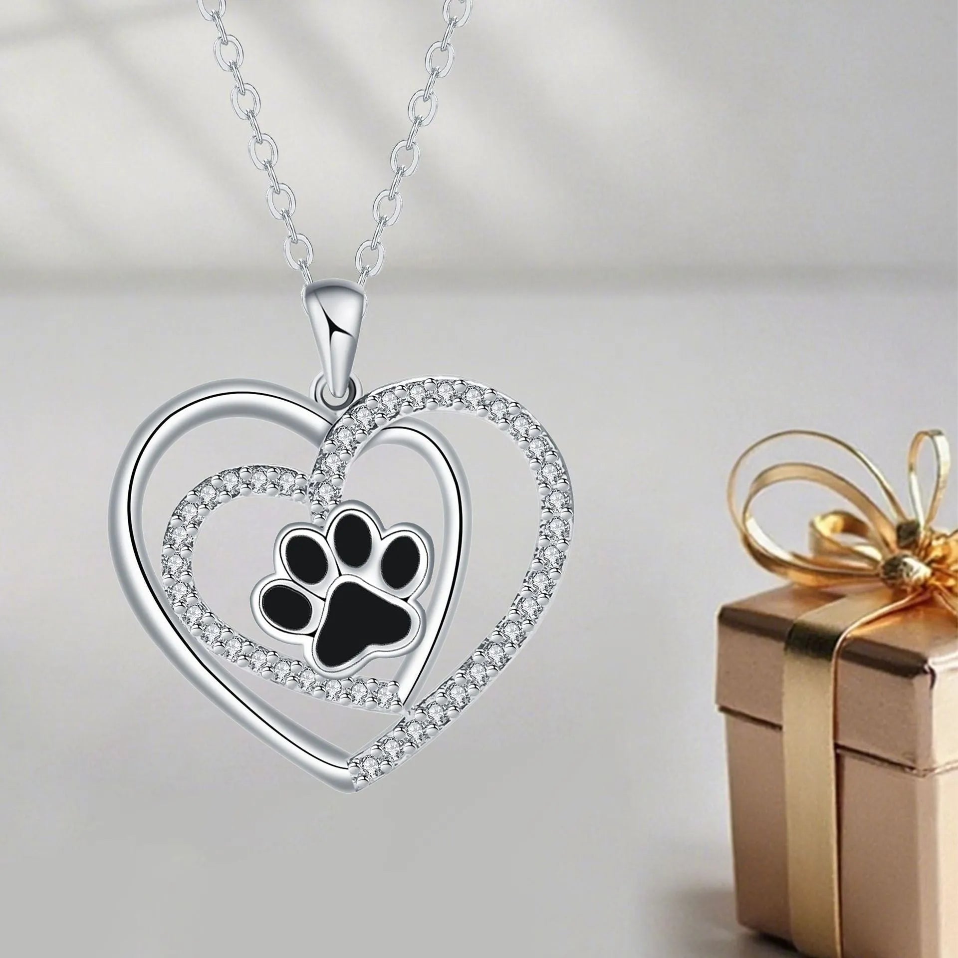Women's dog paw print heart necklace on a cross chain, copper electroplated.
