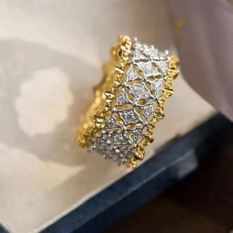 Geometric two-tone gold ring with a round zircon centre on a copper band.