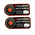 Two white electrostatic warning stickers for Tesla Sentry Mode, each measuring 11 by 5 centimetres.