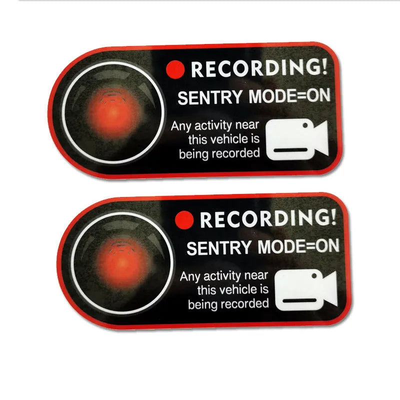 Two white electrostatic warning stickers for Tesla Sentry Mode, each measuring 11 by 5 centimetres.