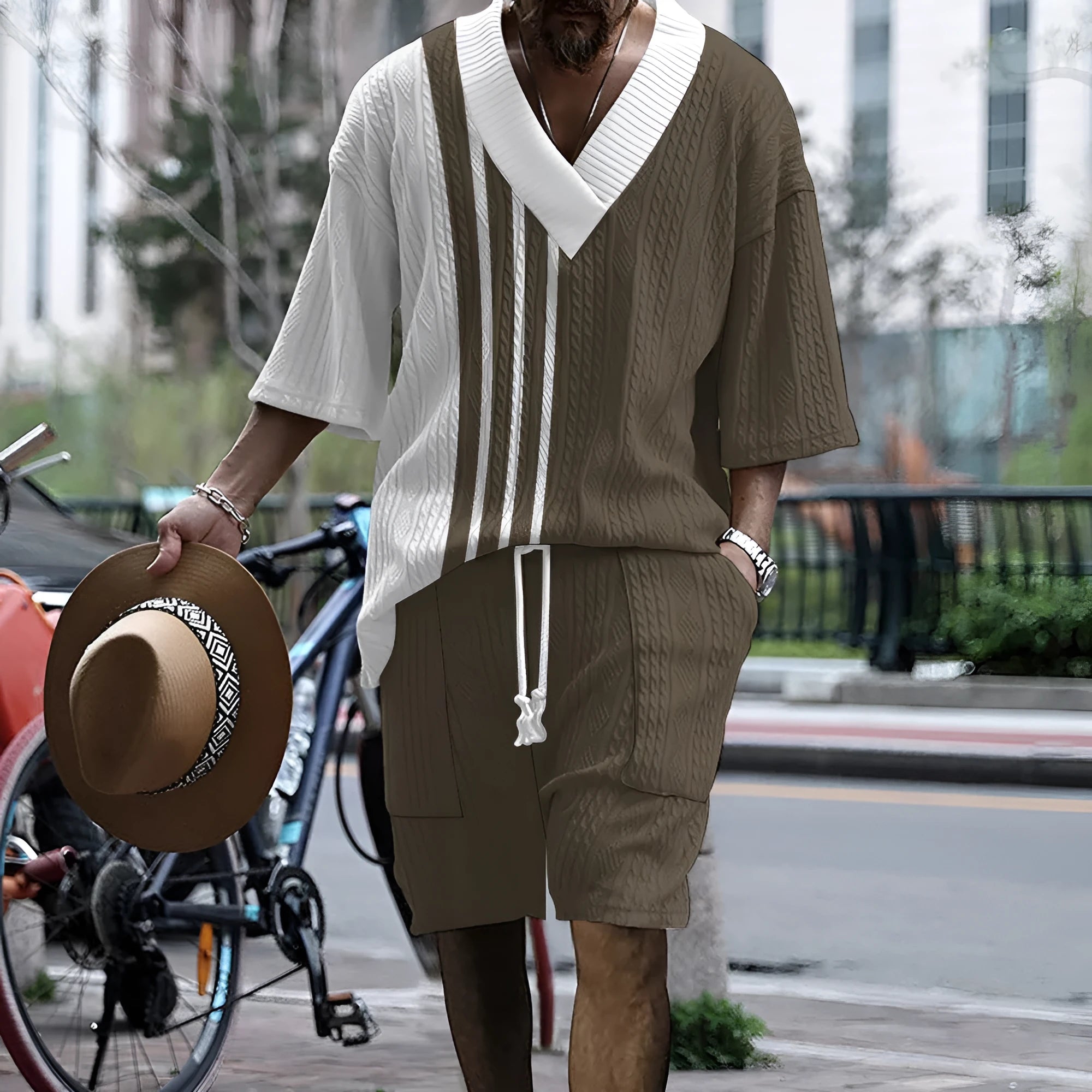 Man wearing a printed drop-shoulder knitted top and matching shorts from a two-piece lounge suit.