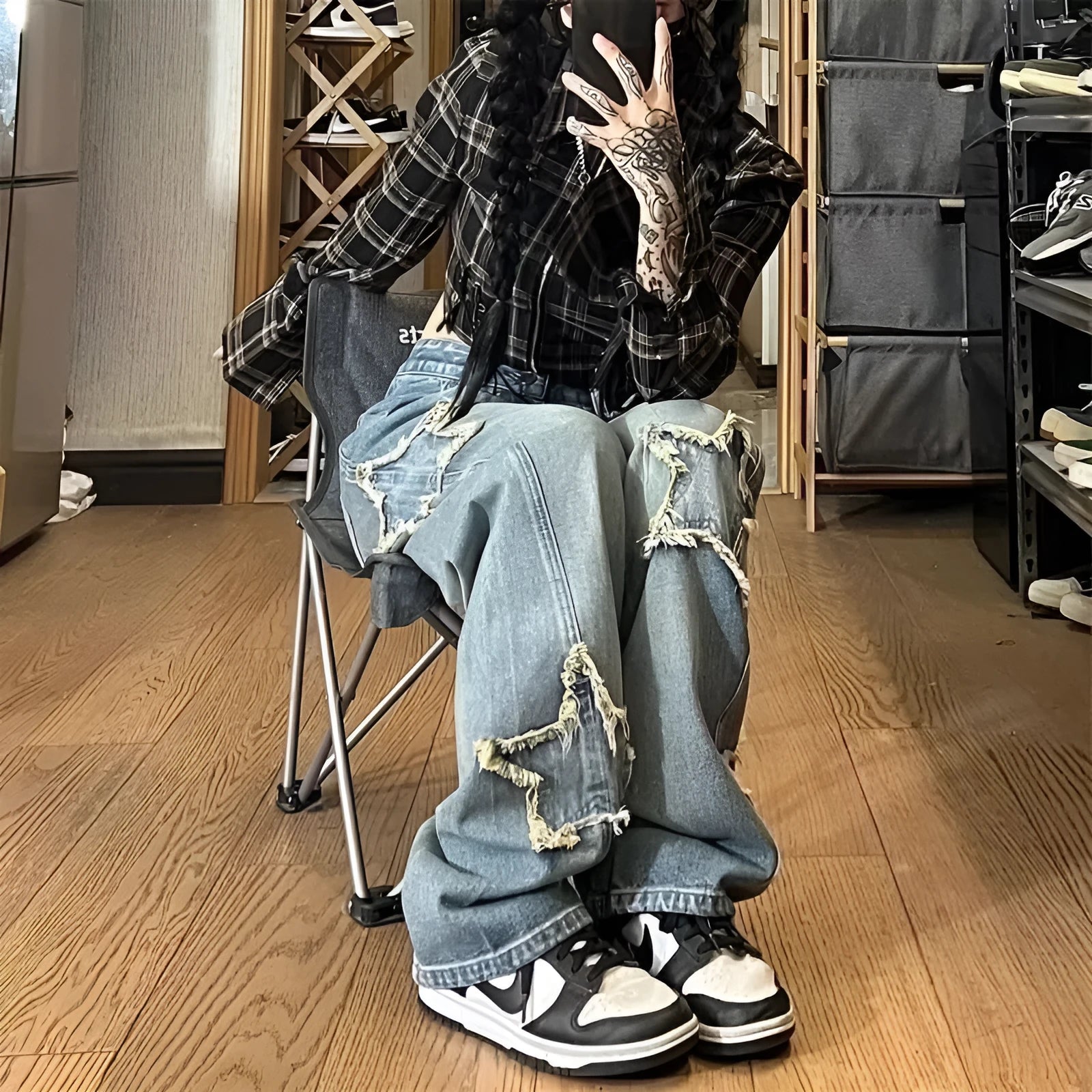 Blue high waist wide-leg denim trousers on a hanger, showing straight leg cut.