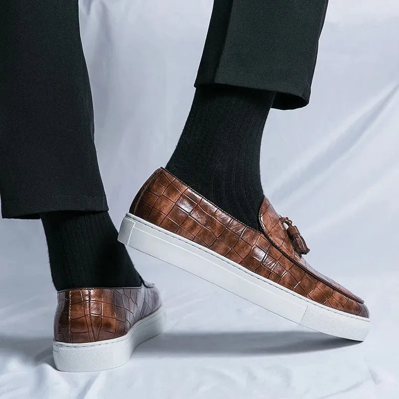 Men's plus-size black tassel sneakers with round toe and rubber sole on a white background.