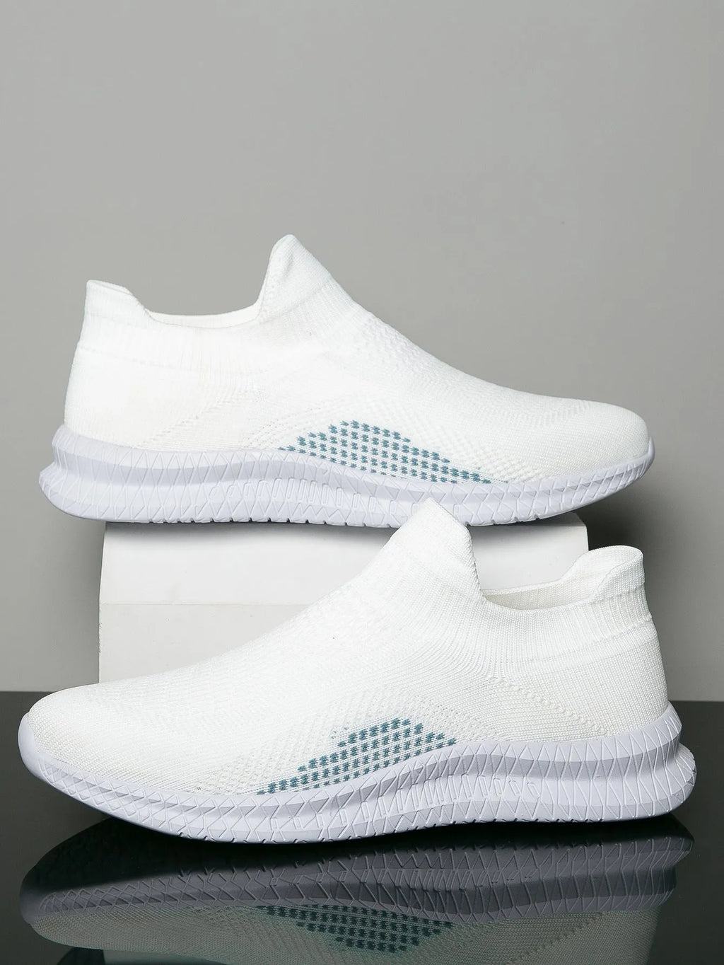 Men's white low-top fabric casual sneakers with a flat heel and round toe on a plain background.