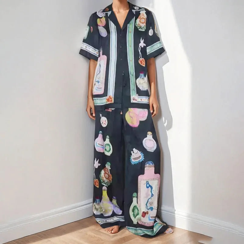 Black women's casual set with cartoon print, featuring a cardigan and matching trousers.