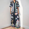 Black women's casual set with cartoon print, featuring a cardigan and matching trousers.
