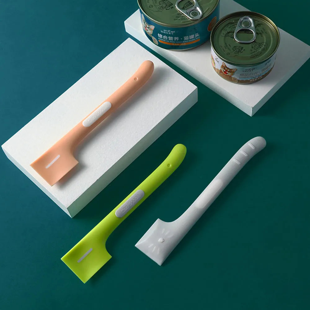 Green long-handled pet food spoon with right-angle head for scraping canned wet food.