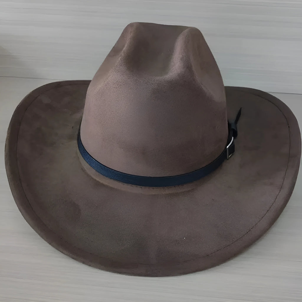 Brown leather velvet curved edge Western cowboy hat with a conical crown on a wooden surface.