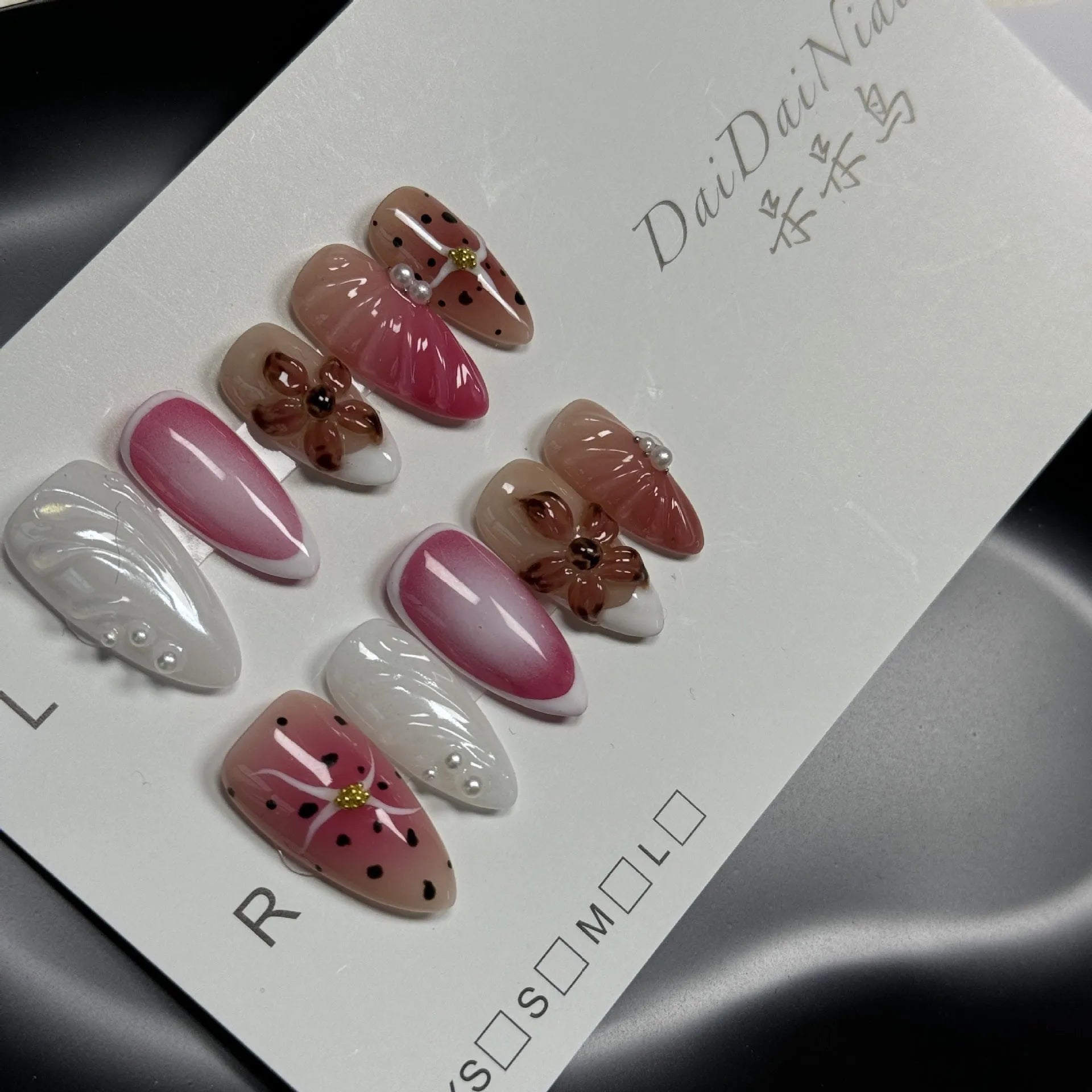 Hand-painted 3D carved nail beauty patches in candy and retro designs on almond-shaped plastic bases.