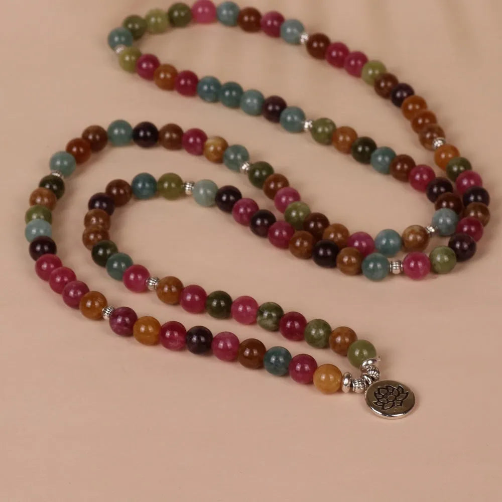 108 bead multi-layer bracelet with lotus charm in tourmaline colour on wrist