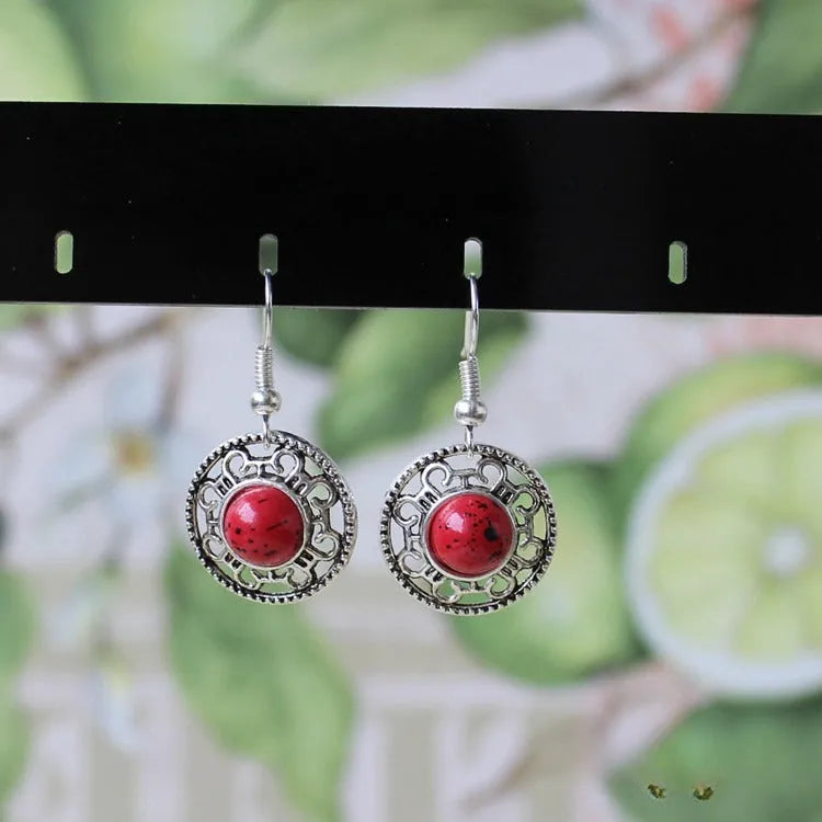 Handmade Tibetan silver earrings with turquoise geometric flower disk design in Miao ethnic style