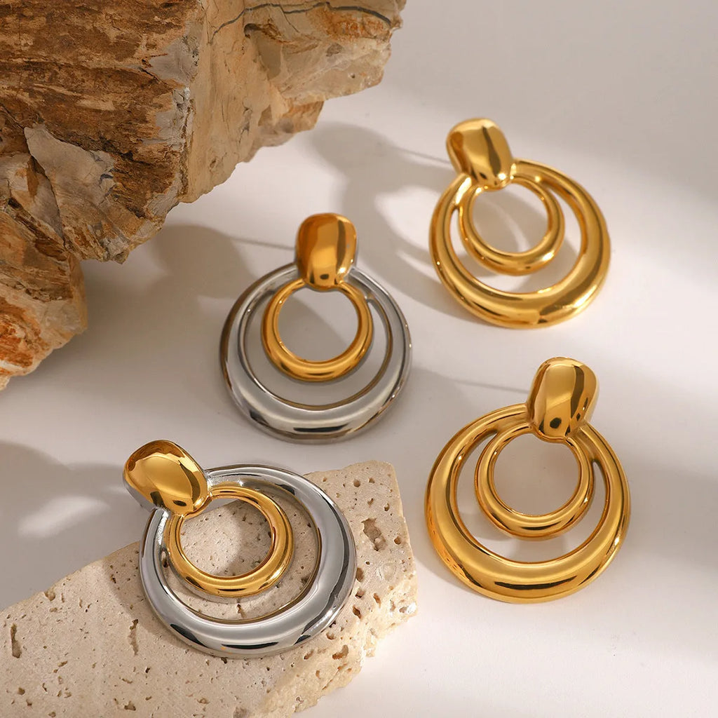 Gold tone geometric round stud earrings with hollow double-layer design on titanium steel backing