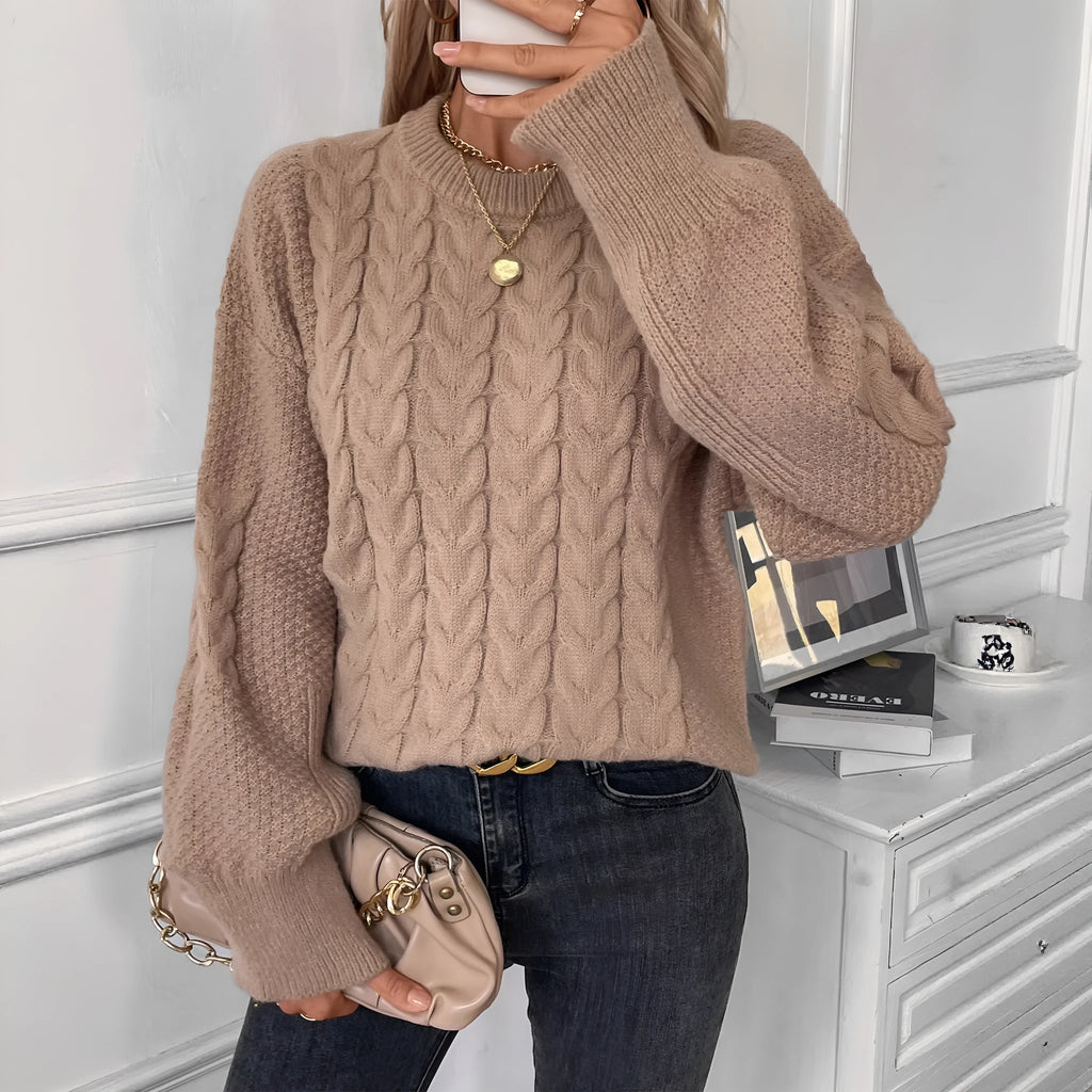 Beige women's loose round neck sweater with a twist design detail on the front.