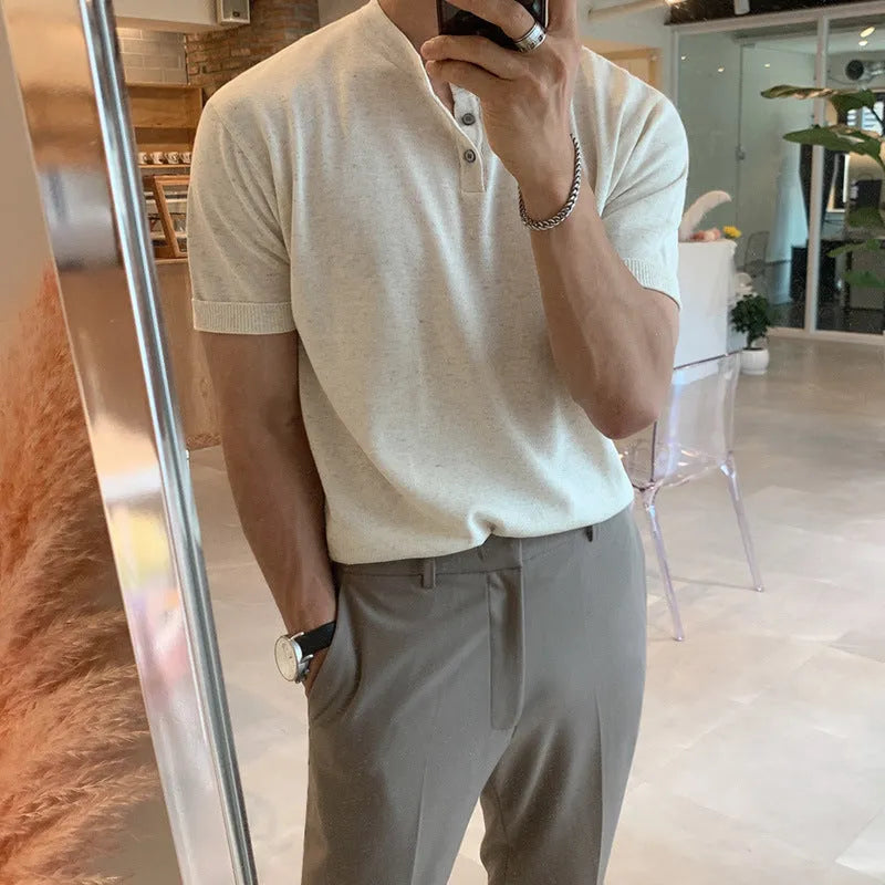 Man wearing a thin black slim-fit knitted short-sleeved pullover shirt.
