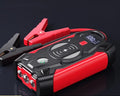 Red car emergency jump starter with thick battery clips and storage box showing 39800W power rating
