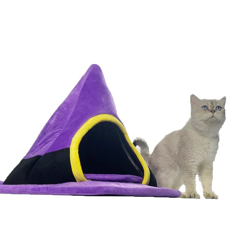 Purple Halloween witch hat-shaped fabric cat bed on a white background.
