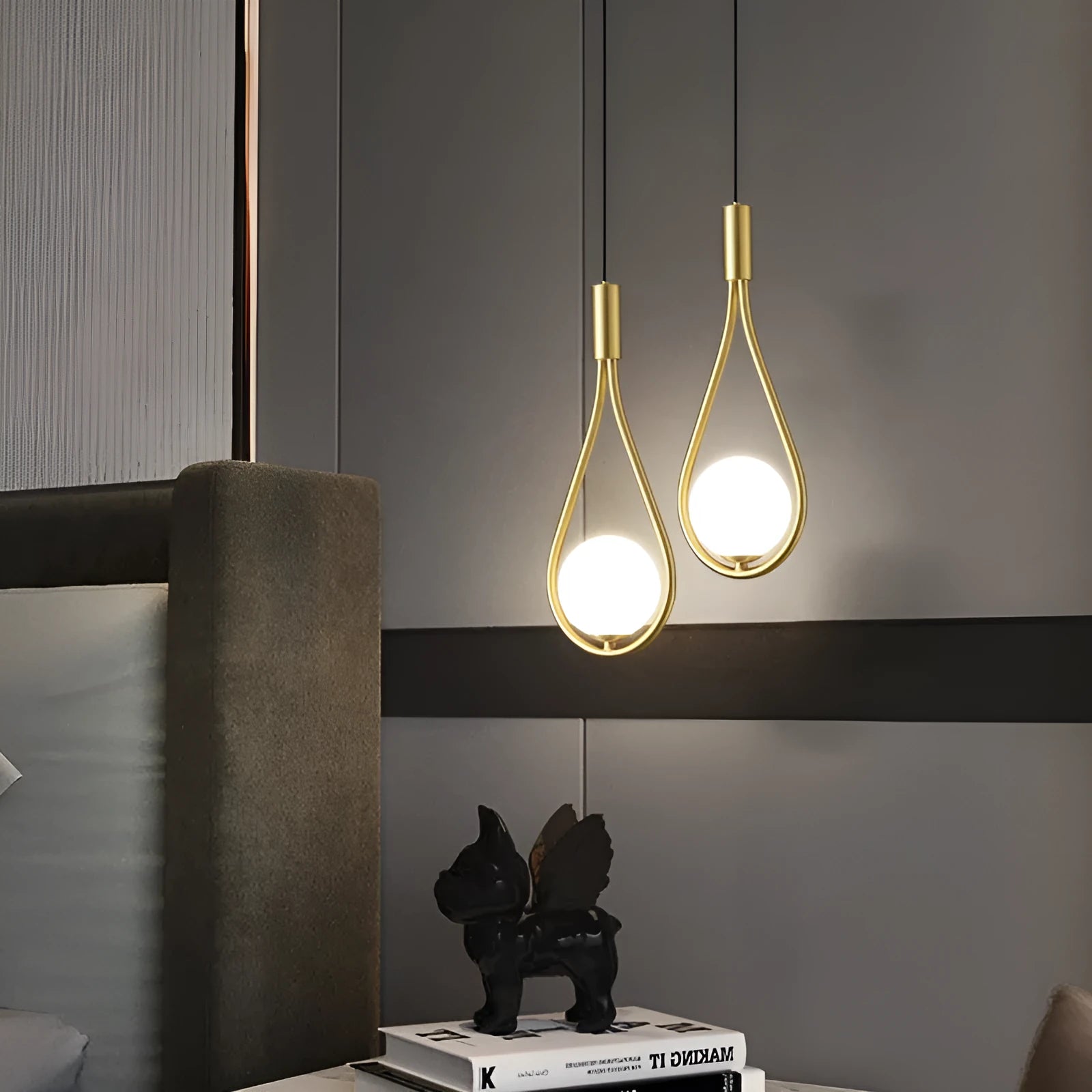 Modern copper bedside chandelier with adjustable hanging cord in minimalist bedroom setting